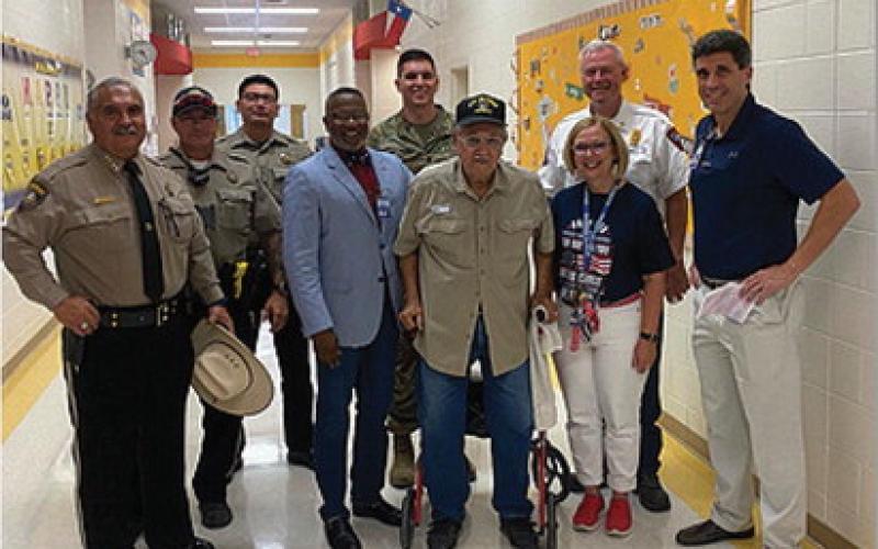 First responders from the Lampasas County Sheriff’s Department and Lampasas Fire Department and members of the Lampasas school district administration pose for a photo with a Vietnam War veteran who was in attendance for Monday’s memorial event. COURTESY PHOTO