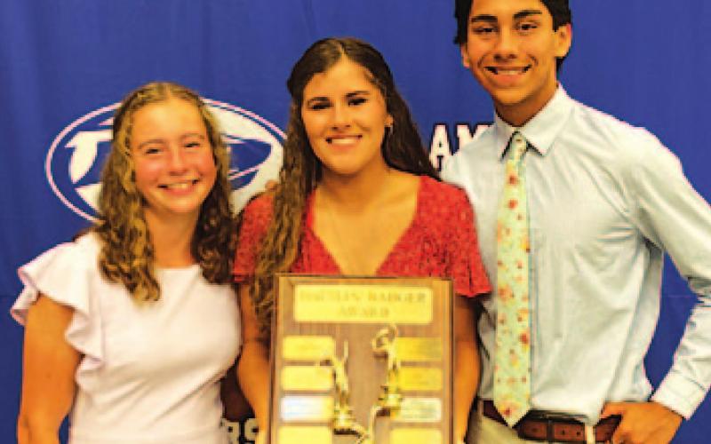 Abby Valdez, left, Kailr Clements and James Vasquez pose with the Battlin’ Badger award on Monday night. COURTESY PHOTO