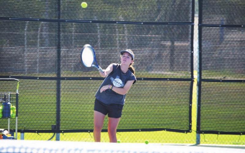 Caroline White practices her serving with other seventh-through ninth-grade participants. HUNTER KING | DISPATCH RECORD