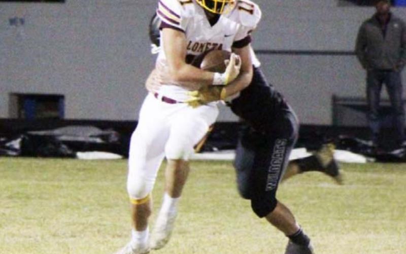 D.J. Smart attempts to break the tackle attempt of a Water Valley defender during the final game of the season. JESSICA MALDONADO | DISPATCH RECORD