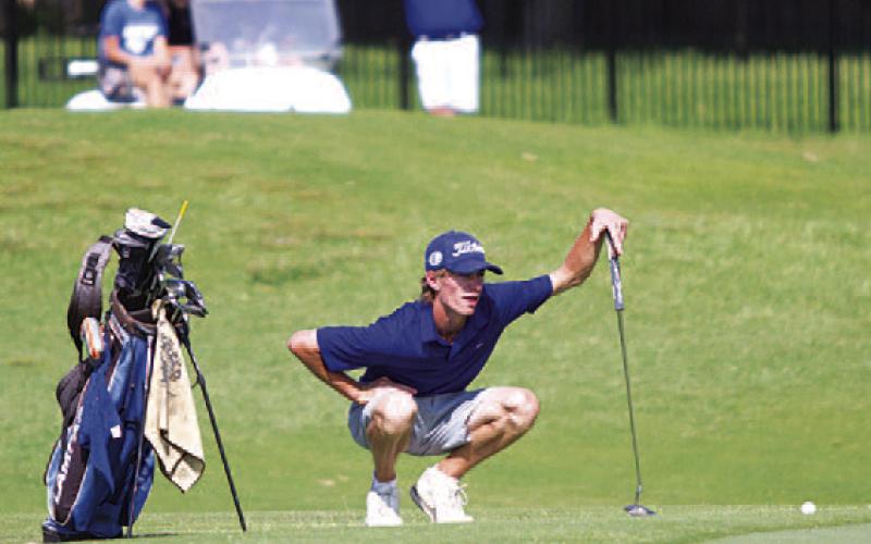 HUNTER KING | DISPATCH RECORD Coulson Plouff reads the green before hitting his putt.
