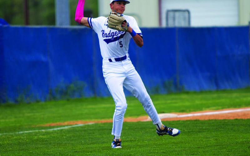 HUNTER KING | DISPATCH RECORD Kade Landry makes a jump throw from the infield grass to record an out.