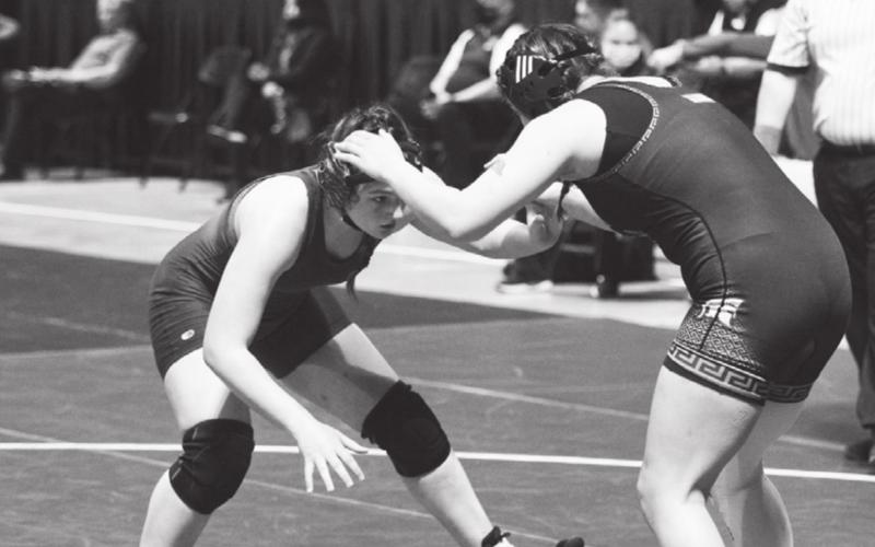 Mia Martell, left, wrestles last week against Burleson Centennial. FILE PHOTO