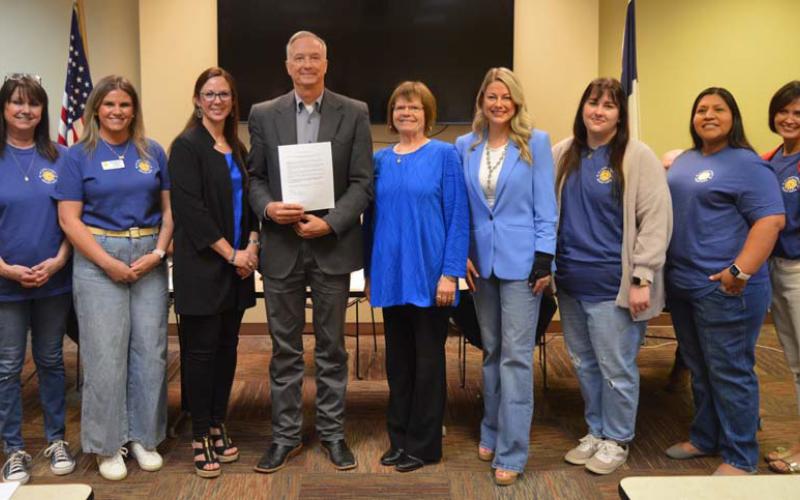 Lampasas Child Protective Services board members and Hill Country Children’s Advocacy Center staff pose for a photo with County Judge Randy Hoyer, who holds a proclamation in support of April’s designation as Child Abuse Prevention Month. ERICK MITCHELL | DISPATCH RECORD
