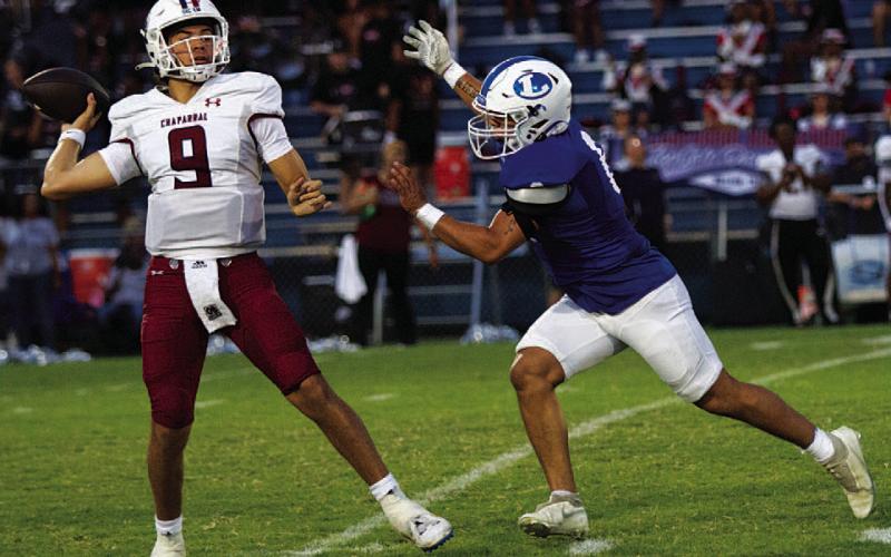 Elias Ayala chases the Chaparral quarterback during last Friday’s game. HUNTER KING | DISPATCH RECORD