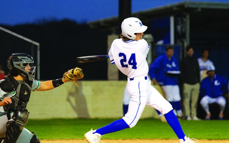 Timber Gholson connects on one of his hits during Tuesday night’s game against Burnet. HUNTER KING | DISPATCH RECORD
