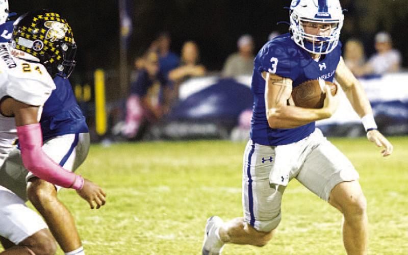 Reed Jerome runs away from a Stephenville defender during last Friday’s district contest. The quarterback continues to lead the Badgers this season. HUNTER KING | DISPATCH RECORD