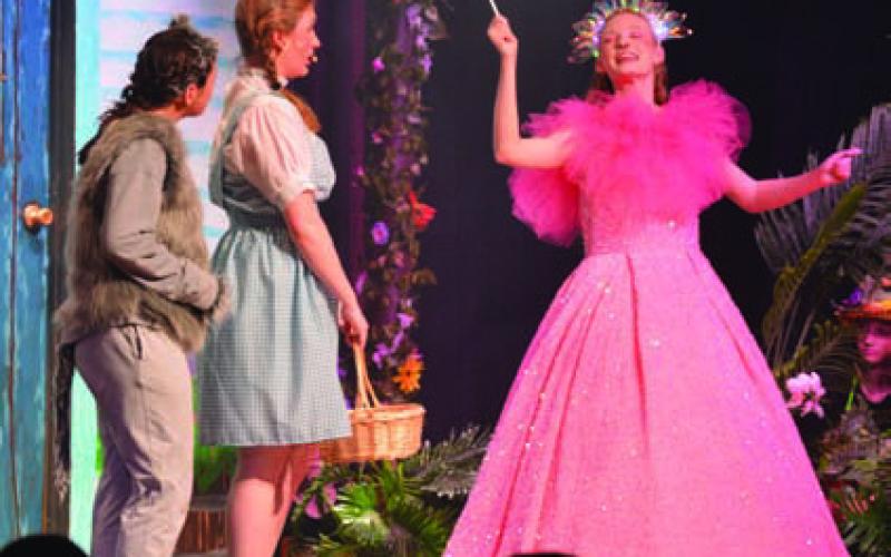 At right, Kenzie Stone as Gilinda the Good Witch welcomes Dorothy and Toto to Munchkinland. ERICK MITCHELL | DISPATCH RECORD