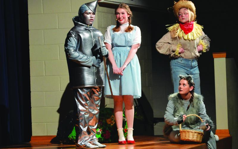 From left, Isabell McGinnis as the Tinman, Samantha Sturgeon as Dorothy, Aurora Walker as Scarecrow and Karson Wells as Toto play out a scene during Saturday’s production of “The Wizard of Oz.” ERICK MITCHELL | DISPATCH RECORD