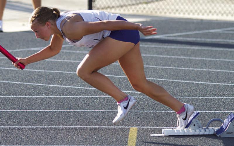 HUNTER KING | DISPATCH RECORD Aimee Weinheimer takes off from the blocks during the 4x100-meter relay.