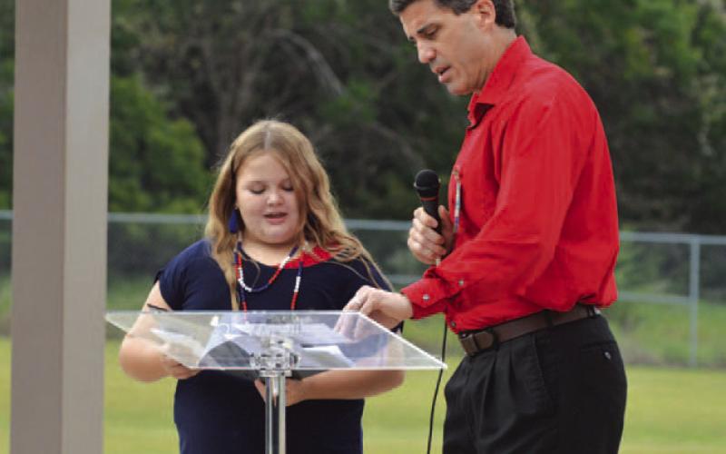 Taylor Creek student Jillian Kidd and Lampasas ISD Superintendent Dr. Chane Rascoe provide a reading of the poem “A Day to Remember.” ERICK MITCHELL | DISPATCH RECORD