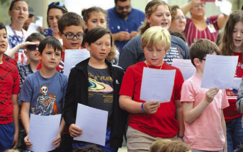 Fifth-grade Taylor Creek Elementary School students sing the national anthem during Wednesday’s 9/11 ceremony. ERICK MITCHELL | DISPATCH RECORD