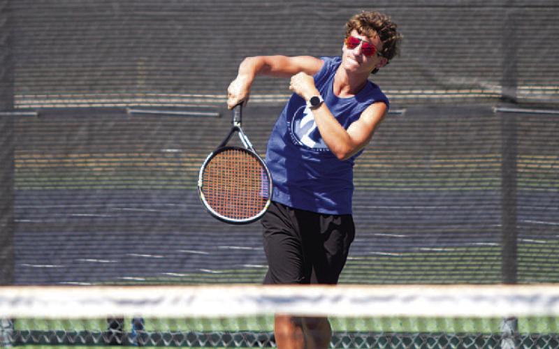 HUNTER KING | DISPATCH RECORD Tyler Ecker sends a serve over the net against Killeen.
