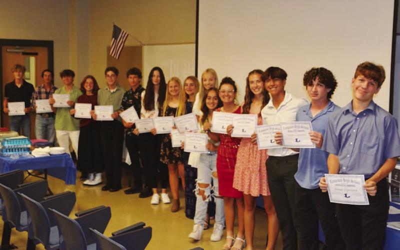 COURTESY PHOTO | KENNETH PEISER Badger tennis players show off their certificates from this week’s banquet.