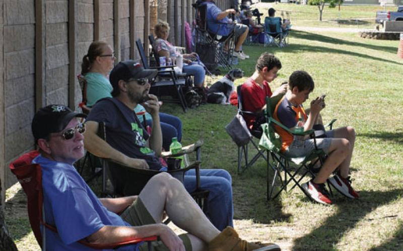 Car owners sit in the shade to take a break from the heat during Saturday’s Sulphur Creek Car Cruise. JOSEPH NEUENSCHWANDER | DISPATCH RECORD