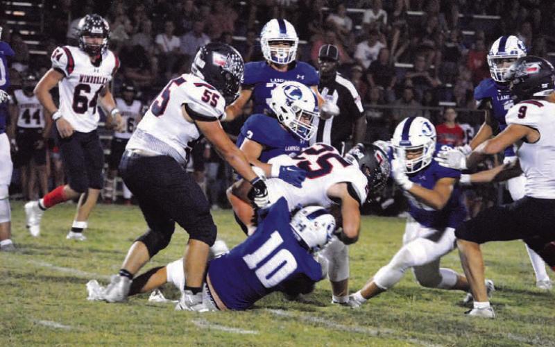 Brock Langford (10) and Reed Jerome (3) are in on the tackle of the Wimberley ball carrier. HUNTER KING | DISPATCH RECORD