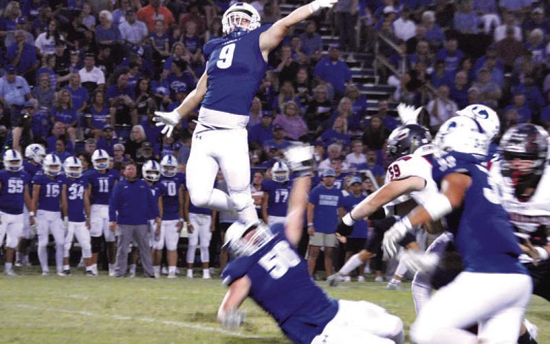 Brady Renfrew goes airborne to try and deflect a pass during last Friday’s game. HUNTER KING | DISPATCH RECORD