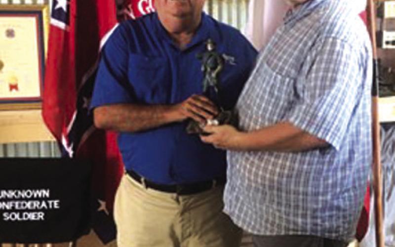 Sons of Confederate Veterans Camp Commander Michael Oliver, at right, presents the first-place trophy, a statue of Robert E. Lee, to John Anderson, winner of the Black Powder Turkey Shoot held Oct. 5. COURTESY PHOTO