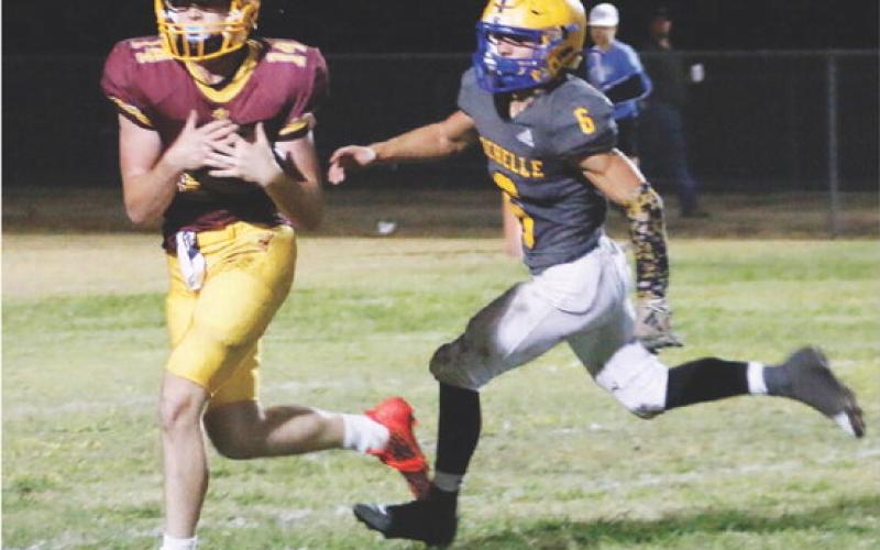 Colten Whitehead catches a pass in stride, scoring one of Lometa’s two passing touchdowns. MASON HINES | DISPATCH RECORD