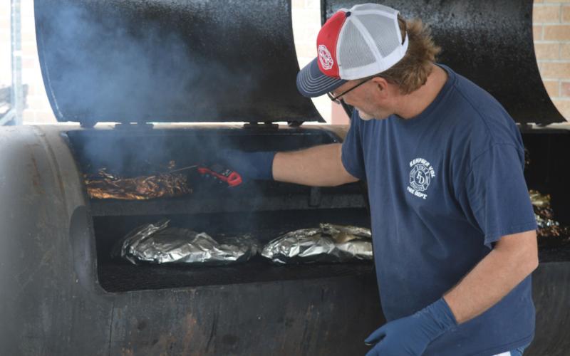 Kempner Volunteer Fire Department Capt. Todd Burkett ensures the brisket is cooked to the perfect temperature. Barbecue sandwiches and meal plates prepared by the KVFD volunteers were served Saturday as part of the department’s annual fundraiser. erick mitchell | dispatch record