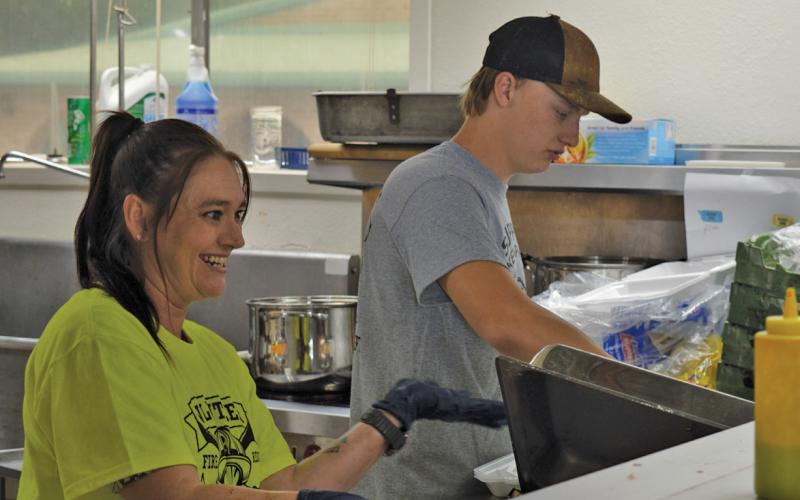 erick mitchell | dispatch record Casey Chapman and Caden Tatum are busy serving those who attended the KVFD BBQ &amp;amp; Auction held Saturday at the fire station on Pecan Street. Funds raised will go toward the purchase of new equipment for the department.