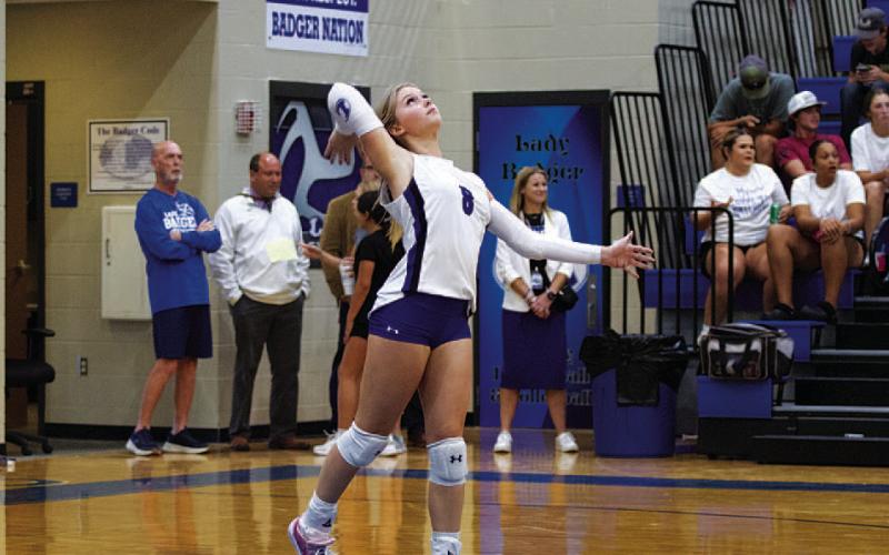 HUNTER KING | DISPATCH RECORD Scout Barton serves the ball during Tuesday’s match.