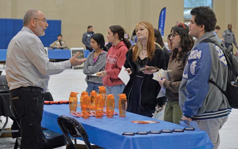 Erick Mitchell| Dispatch record Students speak with a representative from Whataburger during Wednesday’s job fair about possible career options.