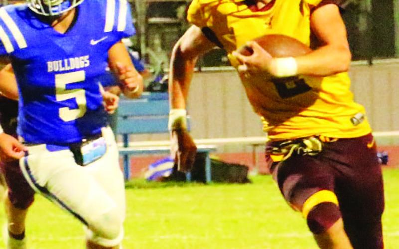 COURTESY PHOTO | MEGAN LUSTY Stone Carr-Jones looks for running room past a Bulldog defender. Carr-Jones finished with 161 yards and a touchdown in the Hornets’ win Friday night.