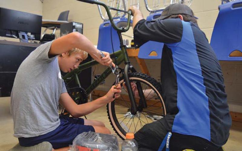 erick Mitchell | dispatch record At left, Elias Vawter applies the finishing touches to his bike before taking it out for a ride during last week’s Wrenches to Wheels event at Lampasas Middle School.