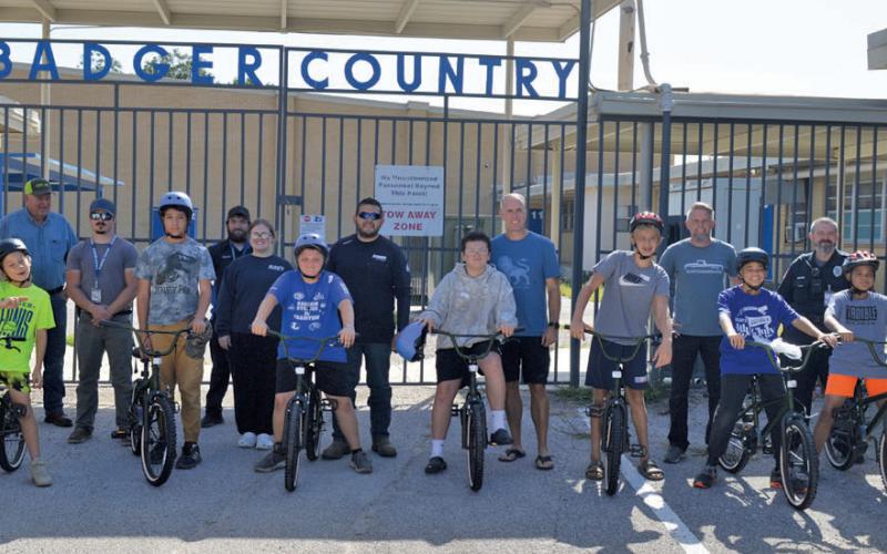 erick Mitchell | dispatch record Lampasas Middls School students and community volunteers pose for a photo after volunteers helped students assemble bicycles during the Wrenches to Wheels program hosted by Workforce Solutions of Central Texas.