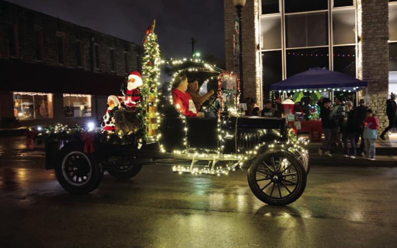 Tommy Allen’s 1918 Ford Model T rolled through the downtown square, ready to welcome the Christmas season during the Holidazzle Parade. JOYCESARAH MCCABE | DISPATCH RECORD