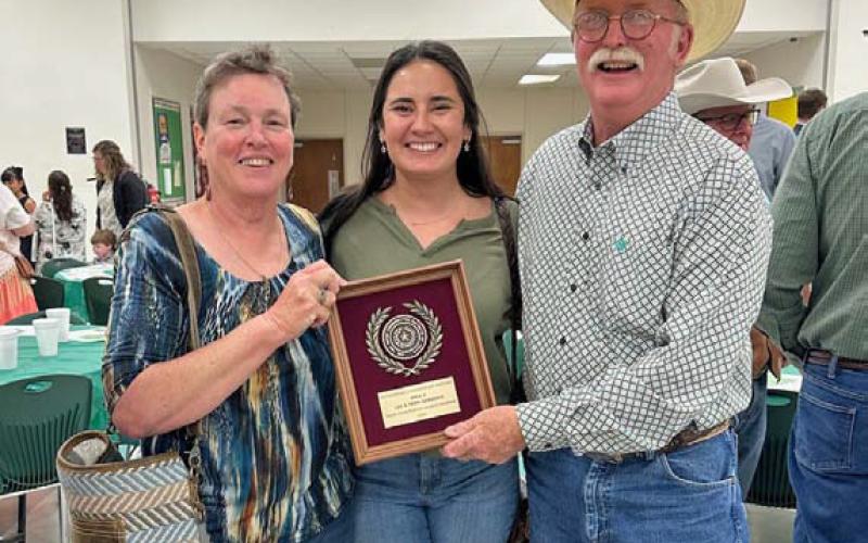 From left to right are Teri Gernentz, Shelby Hilbert and Lee Gernentz with the plaque honoring the Gernentzes for being named the Area V Outstanding Conservation Rancher. courtesy photo