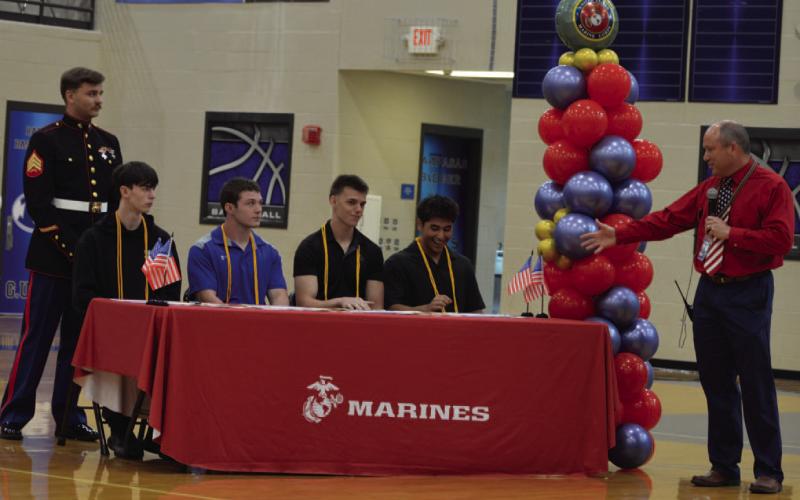 Principal Paul Weinheimer showcases students, from left to right, Elijah Luckenbach, Ronald Pickard, Braydon Matney and Alejandro Montiel who are joining the Marines after graduation. ERICK MITCHELL | DISPATCH RECORD