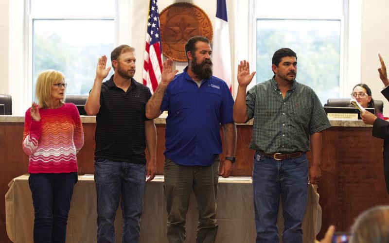 Taking the oath of office at Monday night’s meeting of the Lampasas City Council are newly elected members, from left, Dorothy Person and Edward Gold, and incumbents Charlie Pratus and Eric Hernandez who were re-elected along with Mayor Herb Pearce earlier this month. HUNTER KING | DISPATCH RECORD