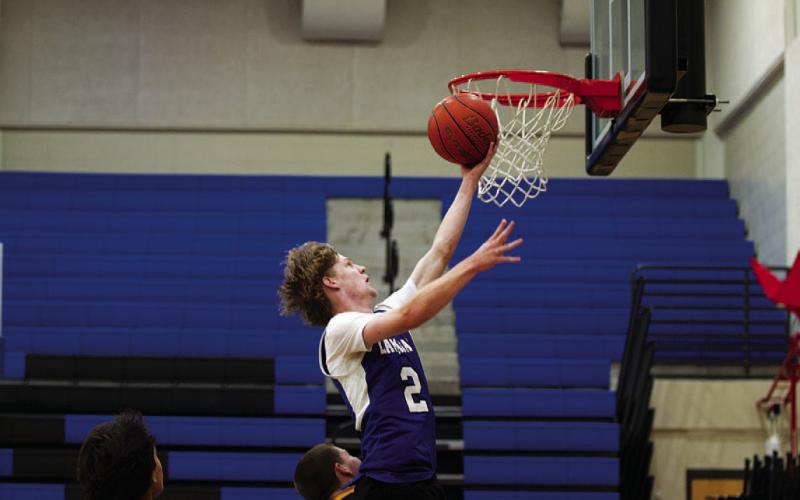 HUNTER KING | DISPATCH RECORD Peyton Sisson reaches toward the basket to finish a layup against Huckabay.