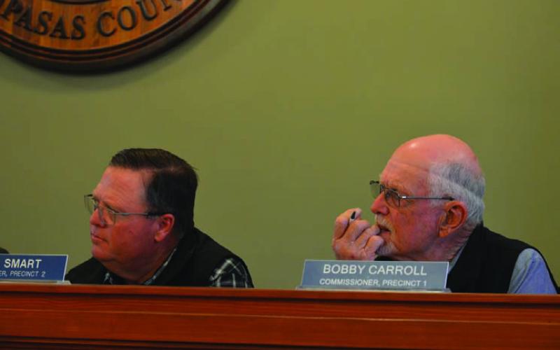 Commissioners Jamie Smart, left, and Bobby Carroll listen to residents’ input on battery energy storage systems or BESS projects in the county. Smart recommended seeking legal advice on how the county might prevent or regulate these developments. ERICK MITCHELL | DISPATCH RECORD