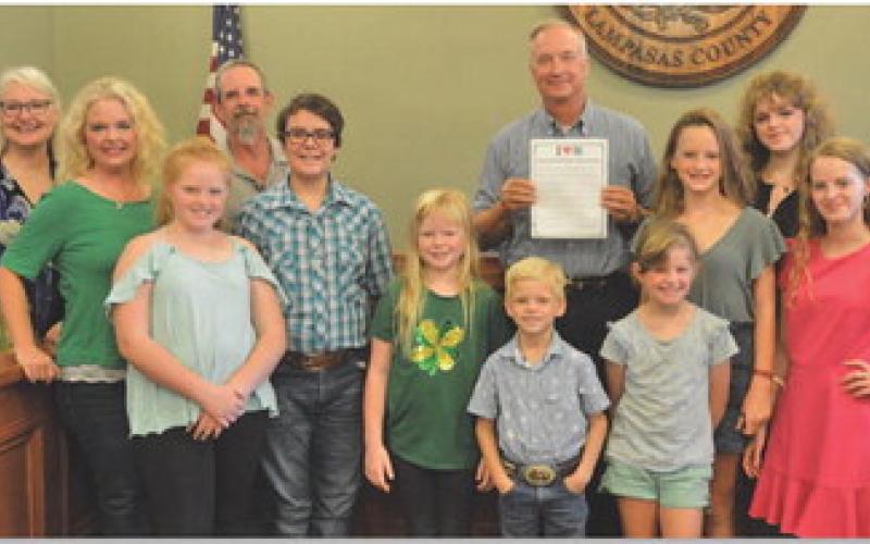Lampasas County 4-H leaders and members pose for a photo with County Judge Randy Hoyer on Monday. The Lampasas County Commissioners Court approved a proclamation calling for the celebration of National 4-H Week, which starts on Sunday. ERICK MITCHELL | DISPATCH RECORD