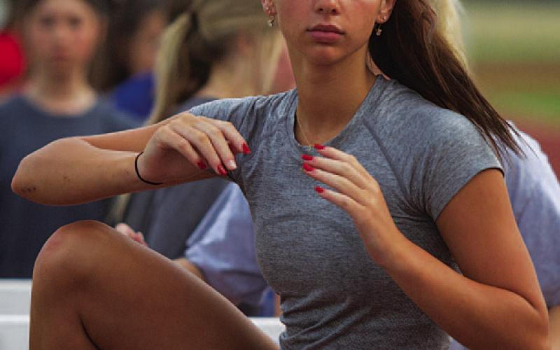 HUNTER KING | DISPATCH RECORD Landry White works on flexibility in the hurdles.