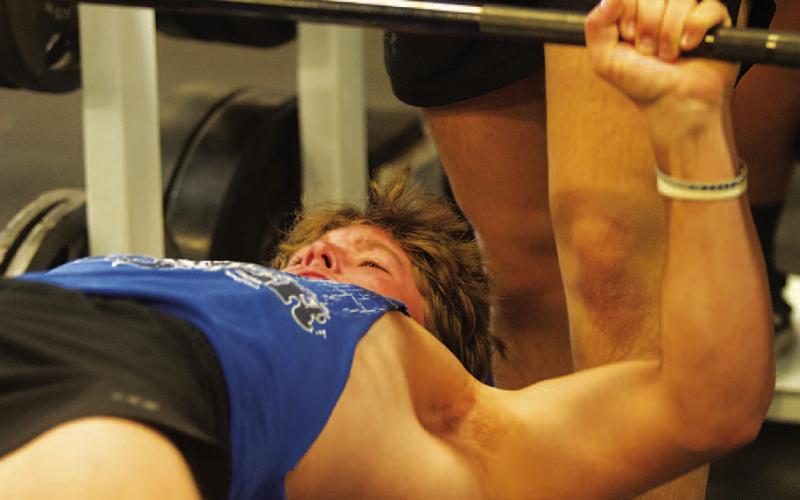 HUNTER KING | DISPATCH RECORD Reed Jerome lifts weights during the first morning of SWAT on Monday.