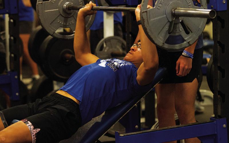 Ty Johnson lifts during incline bench press at the first day of SWAT on Monday. HUNTER KING | DISPATCH RECORD