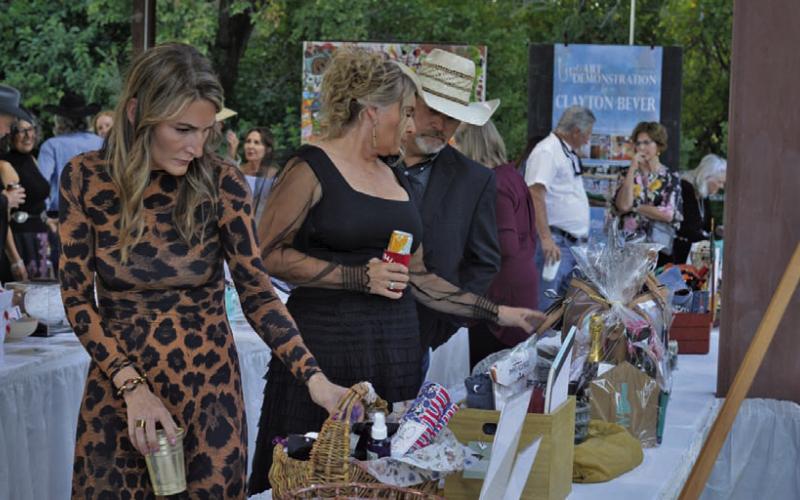 Boots and Blazers Ball attendees were busy eyeing silent aution items on display during Saturday’s event for the Lampasas Association for the Arts. ERICK MITCHELL | DISPATCH RECORD
