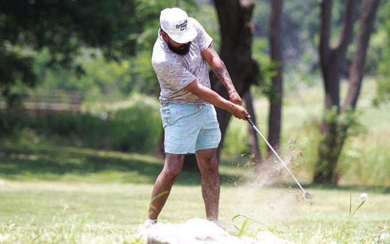HUNTER KING | DISPATCH RECORD JJ Perez hits a shot last Friday during the two-man scramble tournament.