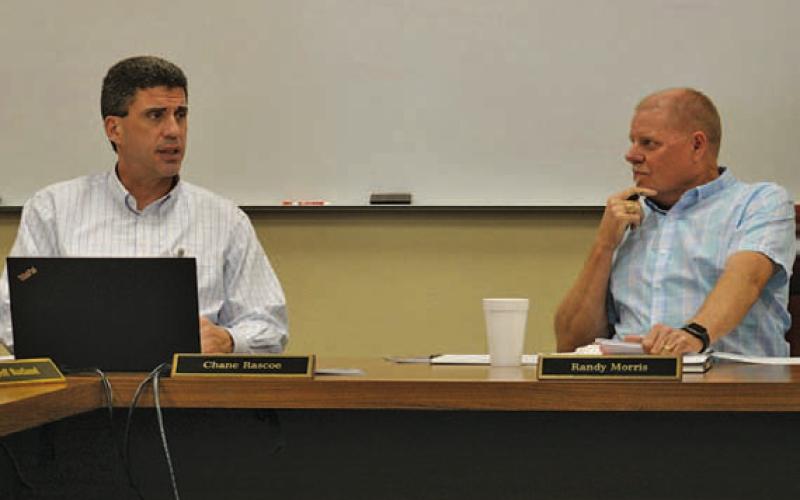 Lampasas ISD Superintendent Dr. Chane Rascoe, left, and LISD Board of Trustees President Randy Morris discuss business during the January school board meeting. ERICK MITCHELL | DISPATCH RECORD