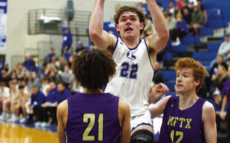 Carter Johnson rises up over a Marble Falls defender for two points in last Thursday’s game. HUNTER KING | DISPATCH RECORD