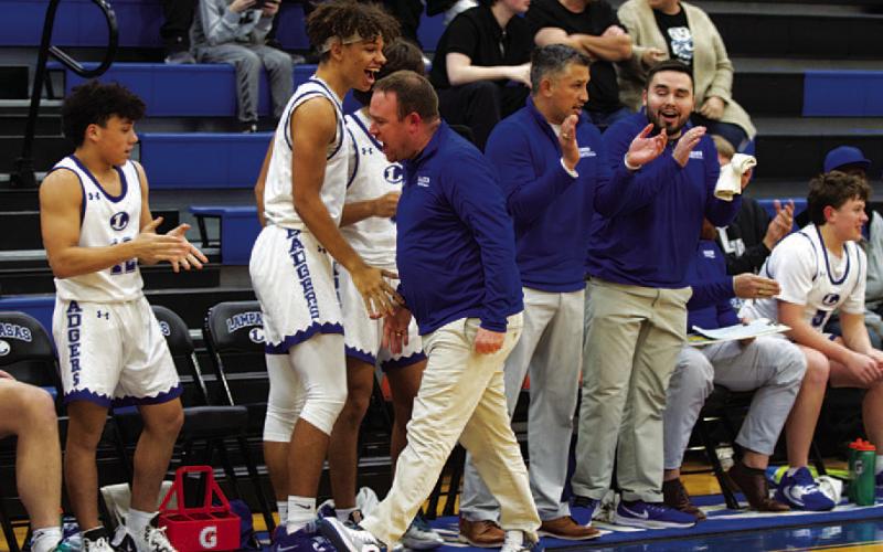 Aaron Nuckles celebrates with his players on the bench once the win over Gateway was secure. HUNTER KING | DISPATCH RECORD
