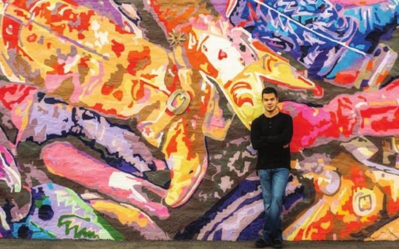 Lampasas High School 2021 graduate Xavier Trinidad is seen in front of the "Boot Roundup" mural at 411 S. Western St., as photographed by Lori Triba/Blue Jean Creative Studio. ©2021 BLUE JEAN CREATIVE STUDIO | COURTESY PHOTO