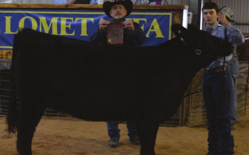 MASON HINES | DISPATCH RECORD Dallas Gomez, at right, captured reserve champion honors with his heifer and also was named winner of the senior showmanship award for cattle.