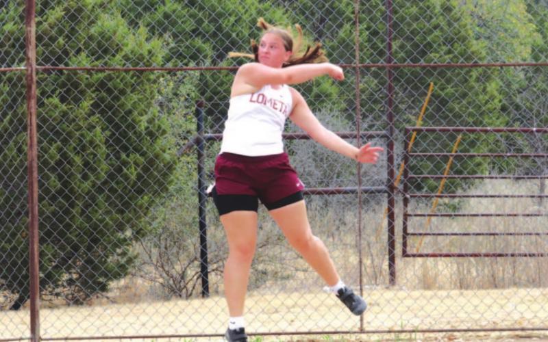 Sierra Tower follows through on a discus throw during the district meet earlier this season. FILE PHOTO