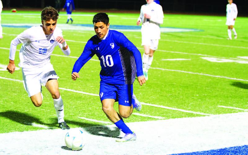 Xavier Contreras dribbles past a Legacy Ranch defender in the 3-2 win on Tuesday. HUNTER KING | DISPATCH RECORD