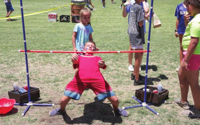 Augustus Rhime dominated the limbo events during Kids’ Day at the Gavin Garrett Soccer Field. CHRIS MILES | DISPATCH RECORD